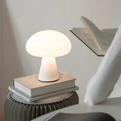 Modern white mushroom table lamp on stack of books, soft ambient light for reading, YH Lamps