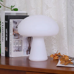 Modern white mushroom-shaped portable table lamp on a wooden desk with books, YH Lamps