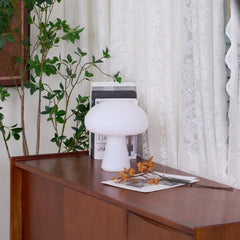 Modern white mushroom table lamp on wooden sideboard by lace curtains, YH Lamps home decor