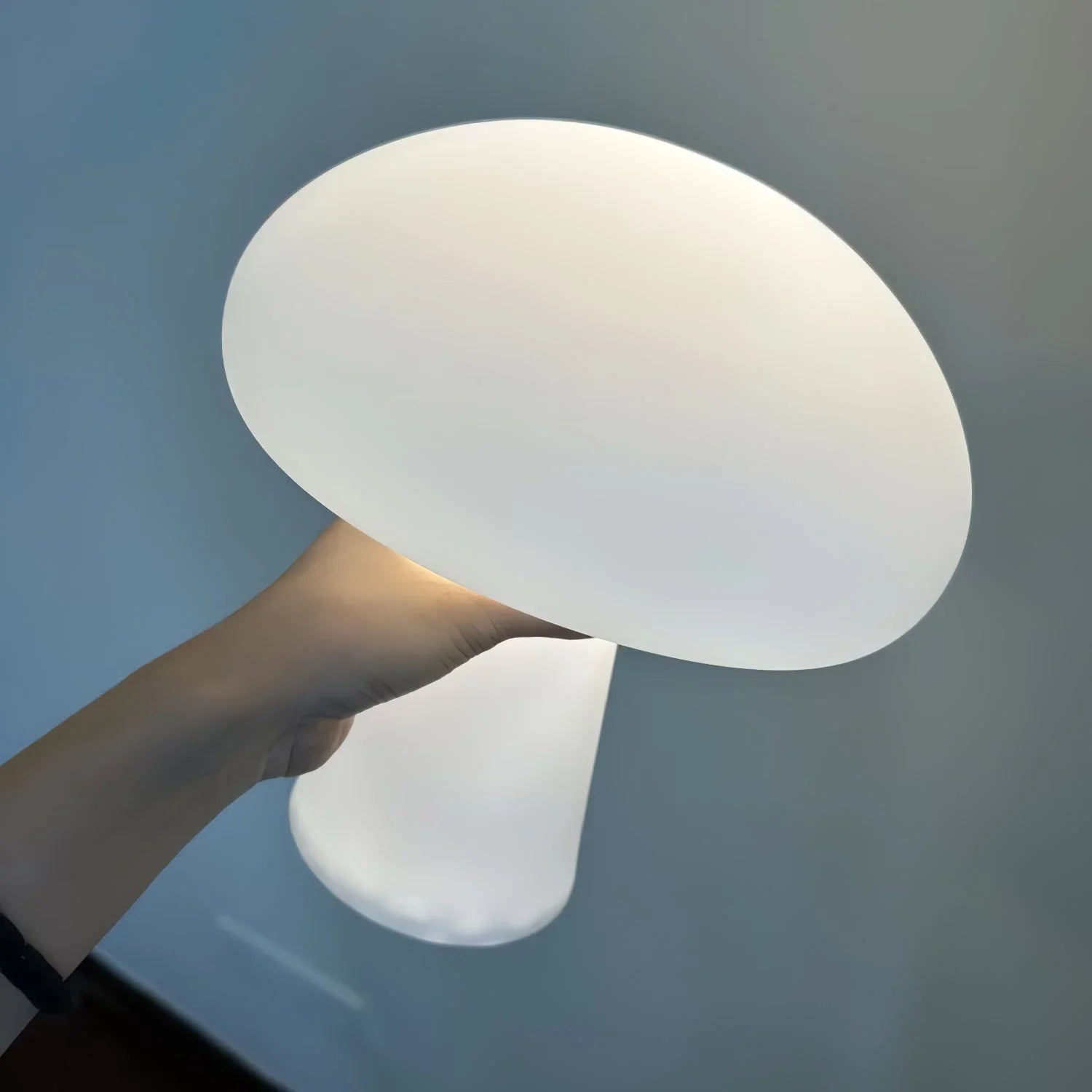 Modern white mushroom-shaped portable table lamp held in hand, YH Lamps home lighting