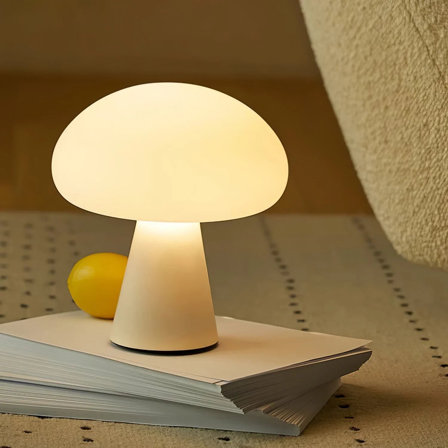 Modern white mushroom table lamp on a book, soft warm glow, YH Lamps home lighting
