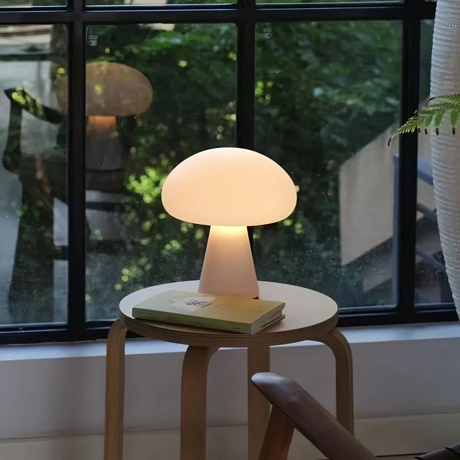 Modern white mushroom table lamp on a round wood side table by a window, YH Lamps