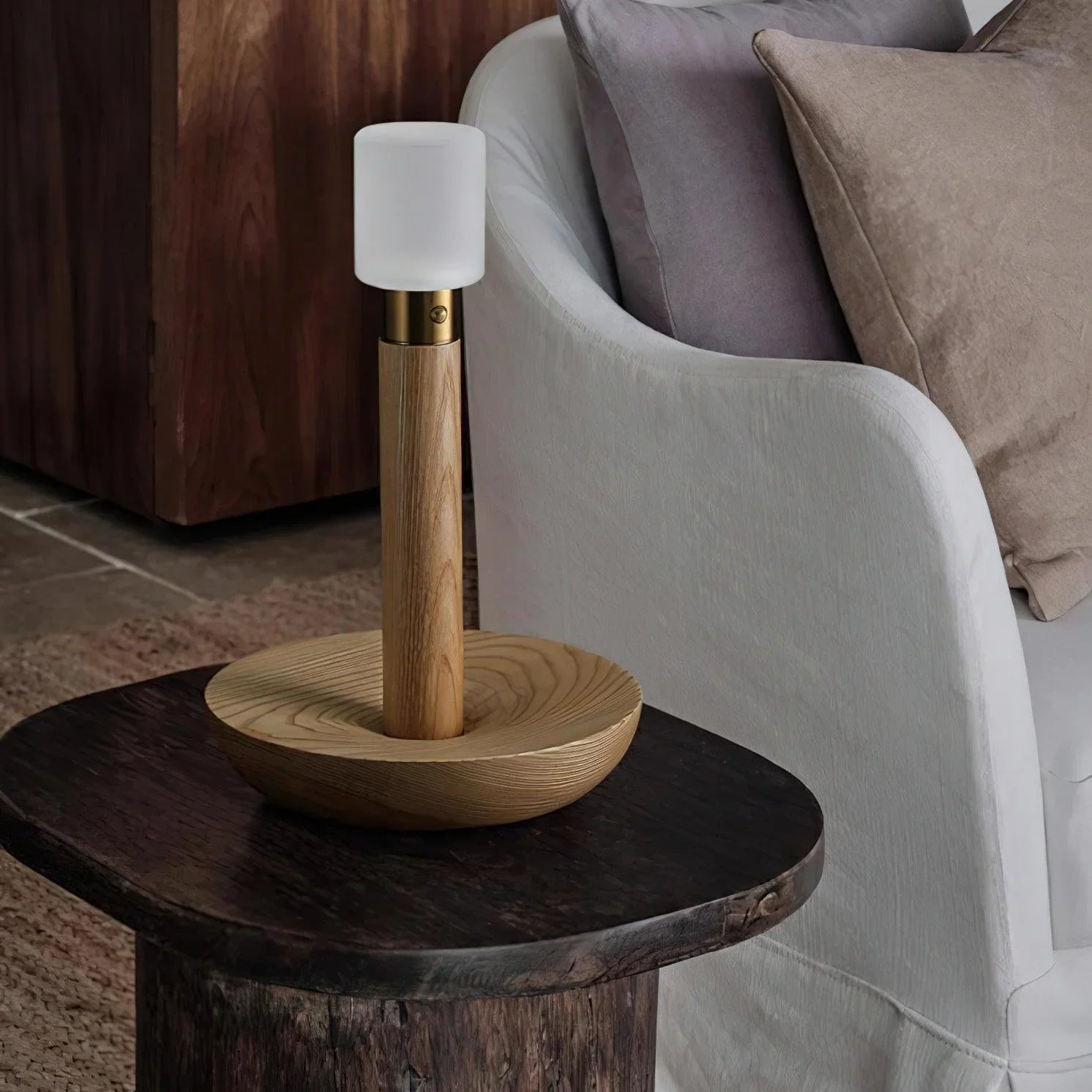 Modern wooden table lamp with frosted glass shade on dark wood side table in cozy living room