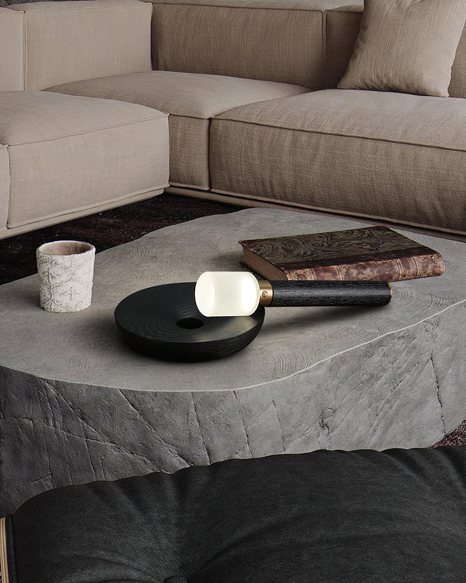 Modern fire stick table lamp with wood base on stone coffee table in stylish living room, YH Lamps