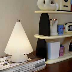 Modern white cone table lamp with touch switch on a desk beside books and a shelf, YH Lamps