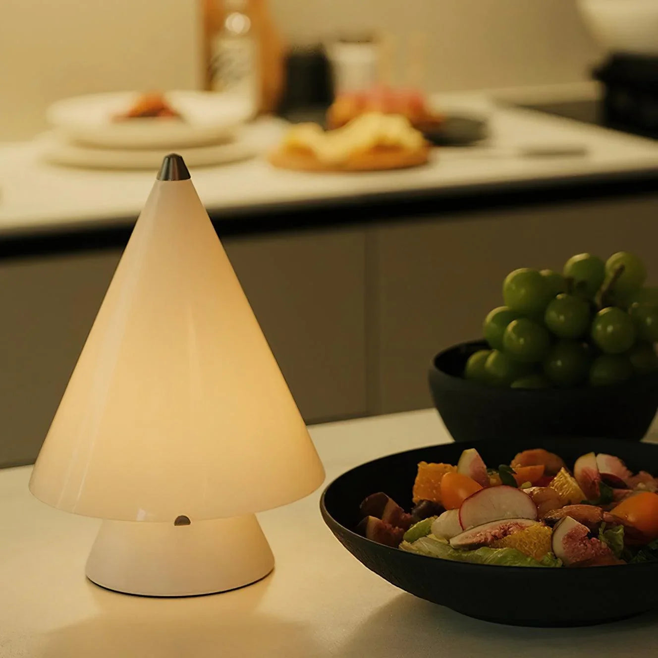 Modern white touch switch table lamp by YH Lamps on a kitchen countertop with salad and fruit bowls