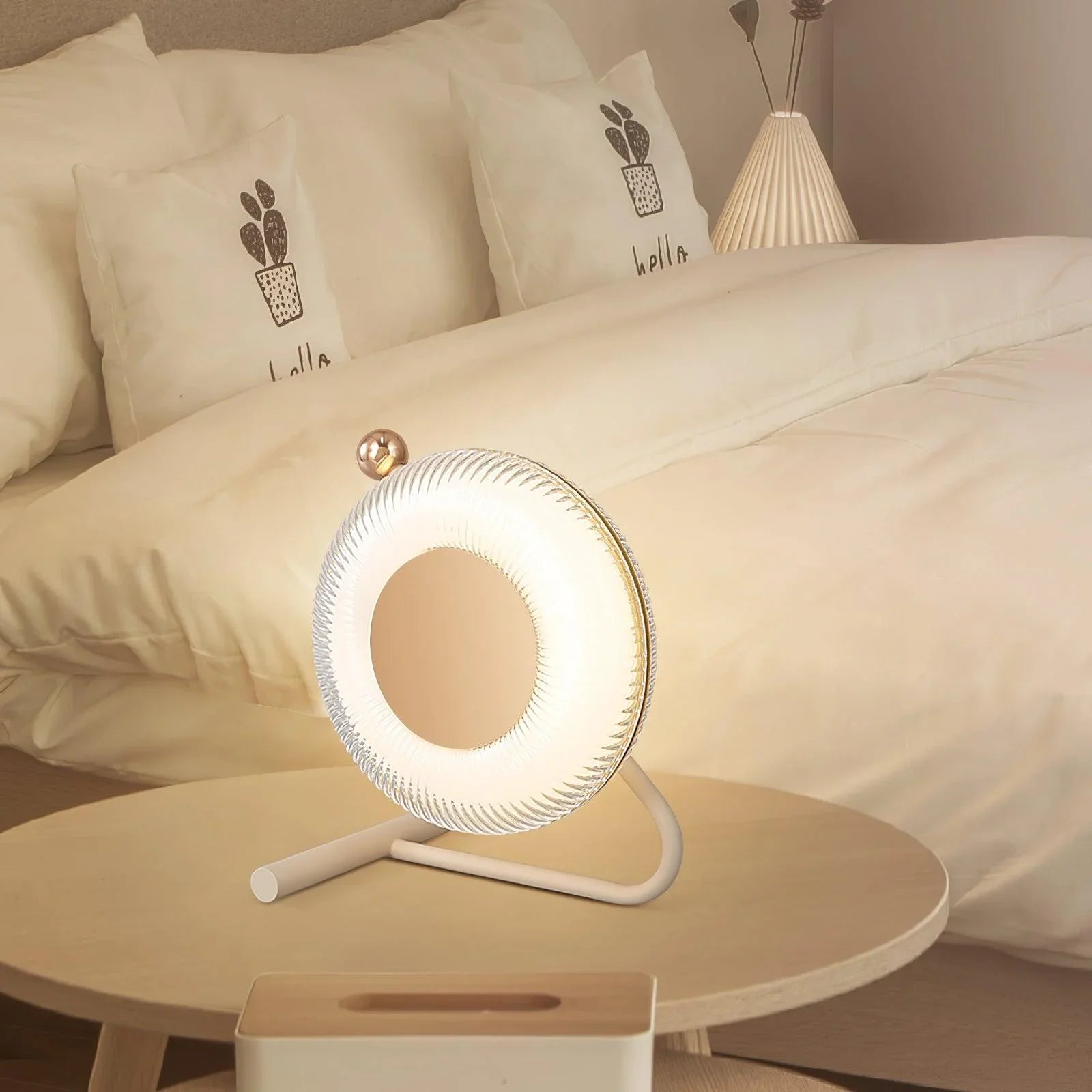 Modern round pink and dark gray table lamp with touch switch on bedside table in cozy bedroom