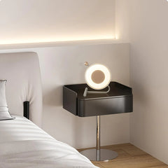 Modern circular table lamp with touch switch on black nightstand in minimalist bedroom at YH Lamps