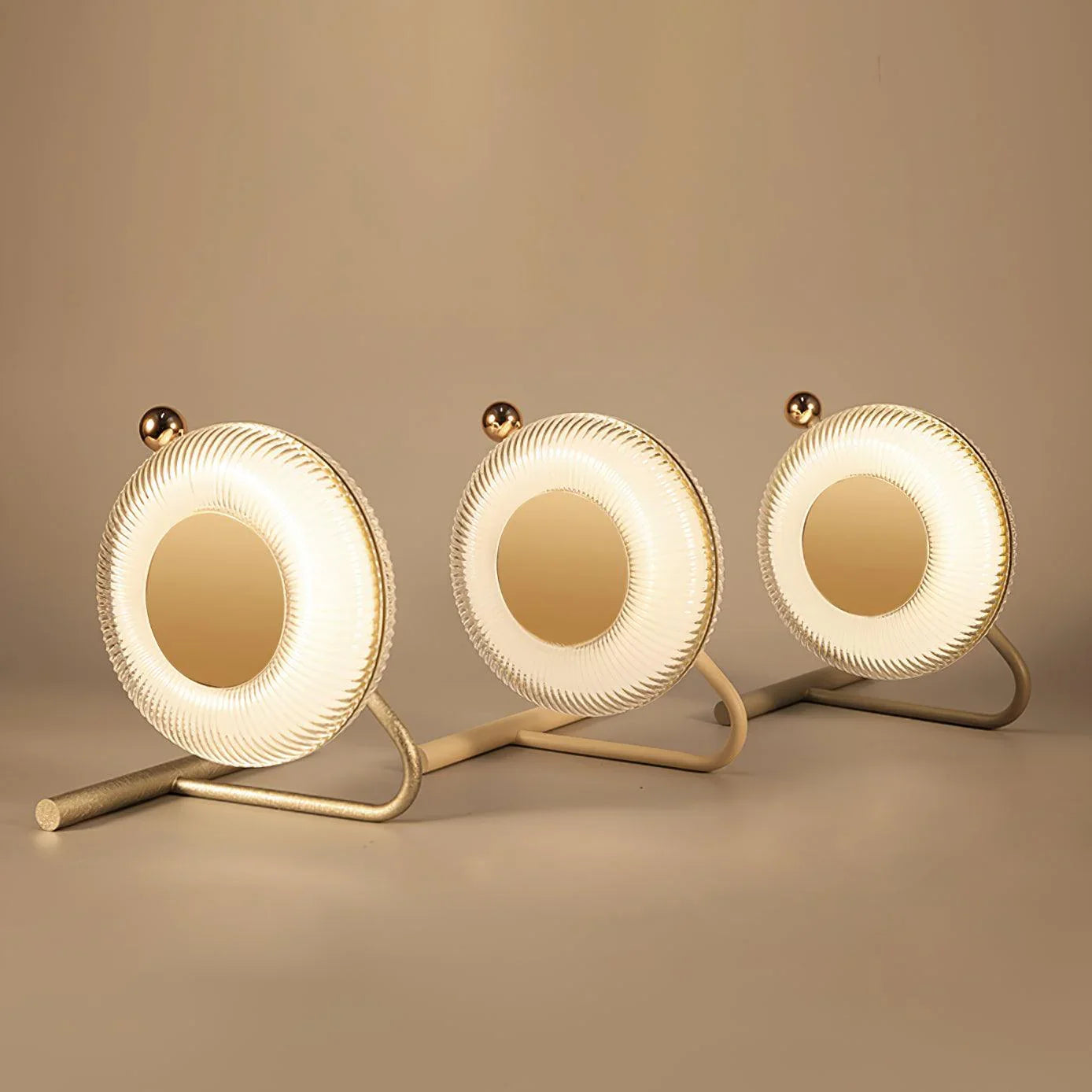 Modern round table lamps with LED light and gold accents on display from YH Lamps