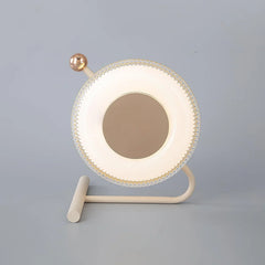 Modern pink and gold table lamp with circular LED design on gray background from YH Lamps