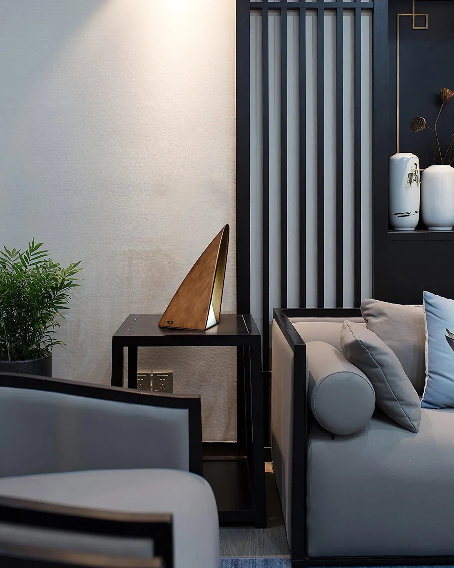 Modern triangular wood table lamp with warm light on black table in stylish living room, YH Lamps