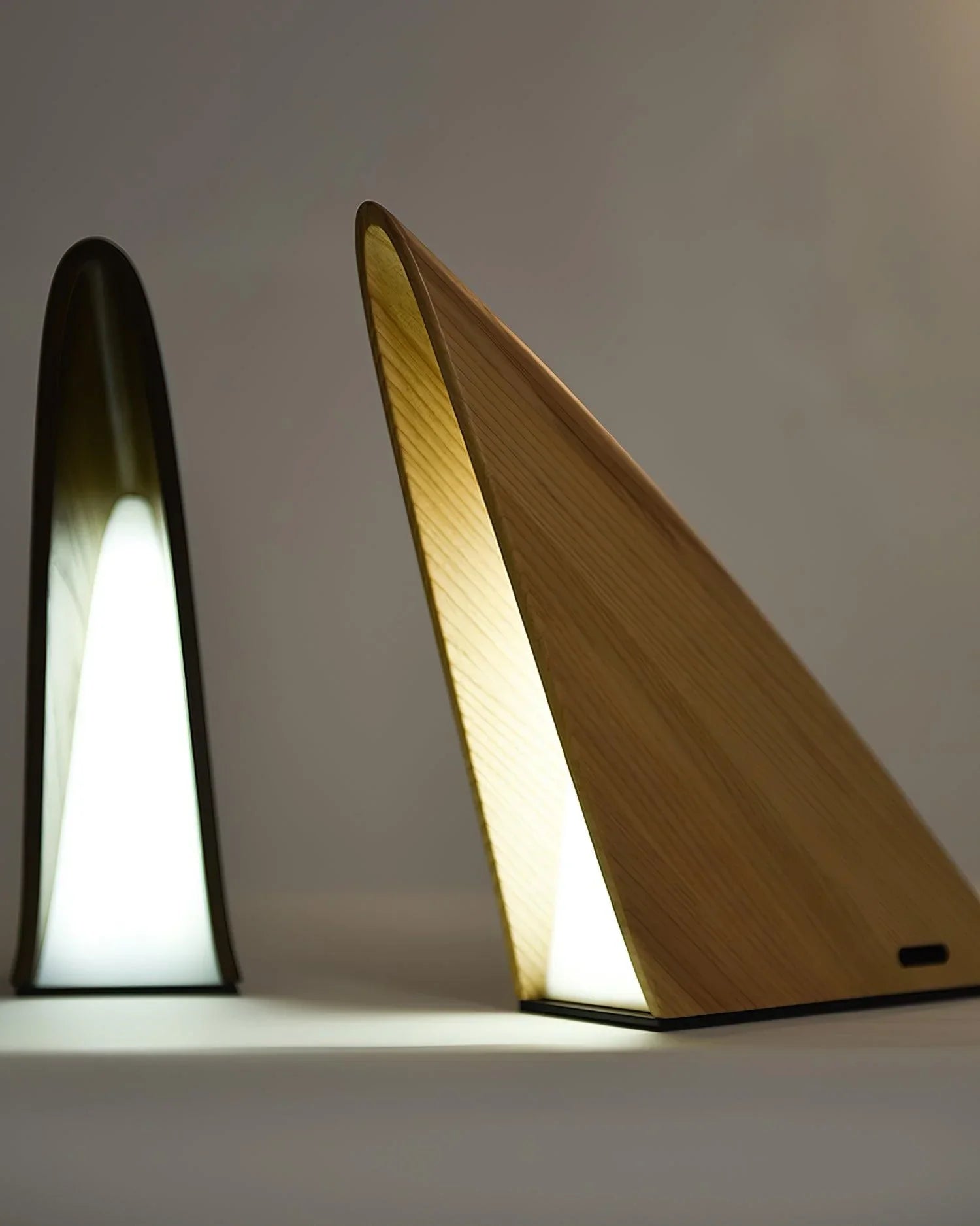 Modern wood triangular table lamps with warm LED light from YH Lamps on neutral background