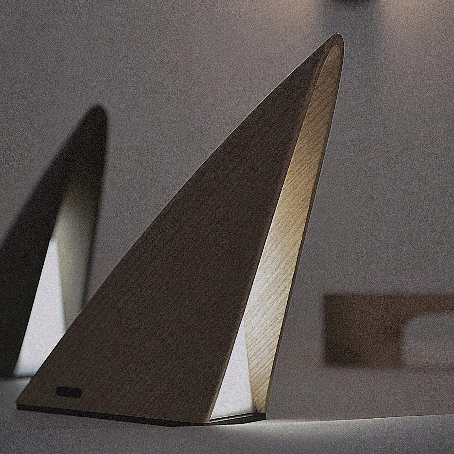 Modern triangular wood table lamp with warm light on a minimalist surface at YH Lamps