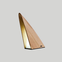 Modern triangular wood table lamp with warm light on neutral background from YH Lamps