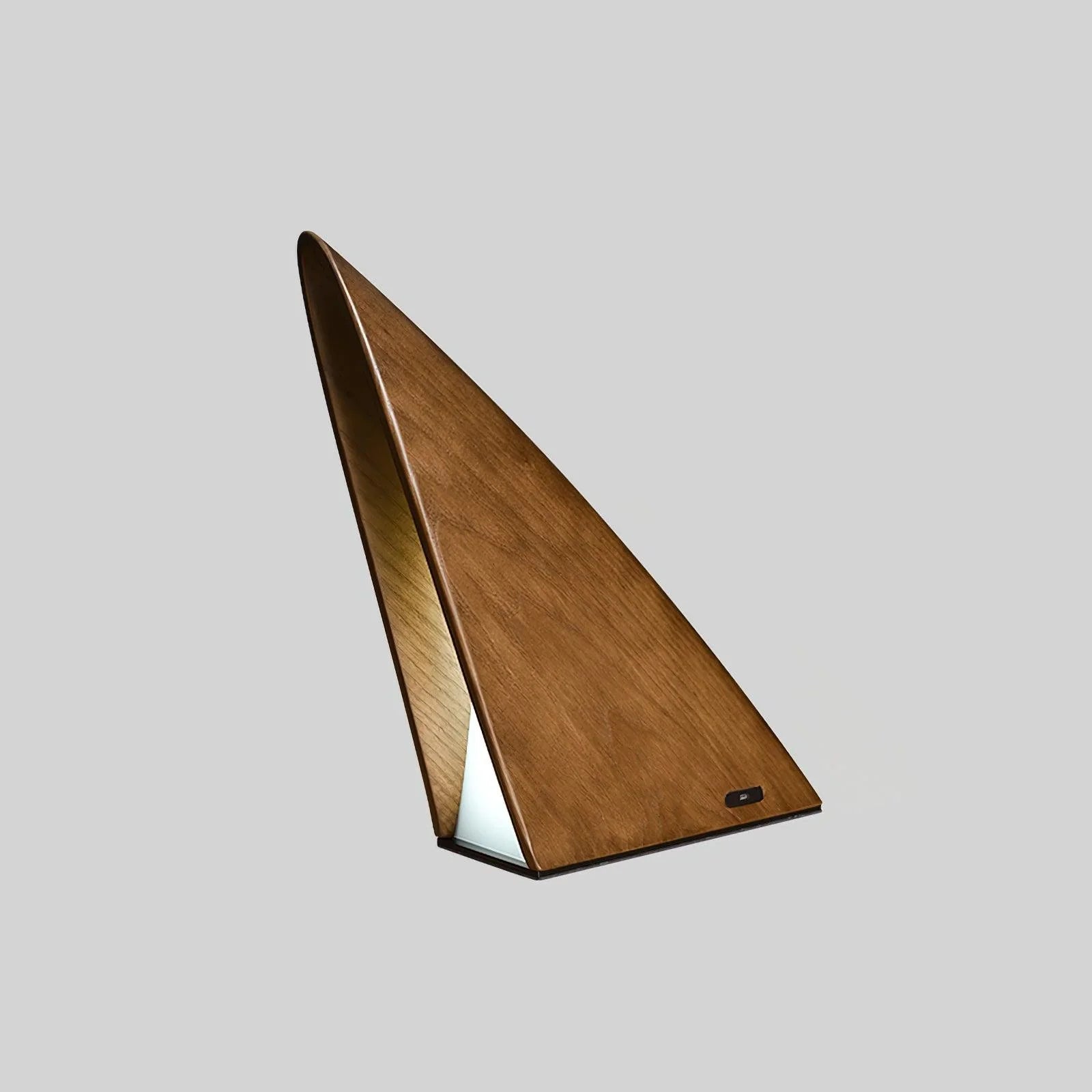 Modern triangular wooden table lamp with warm light on plain background from YH Lamps