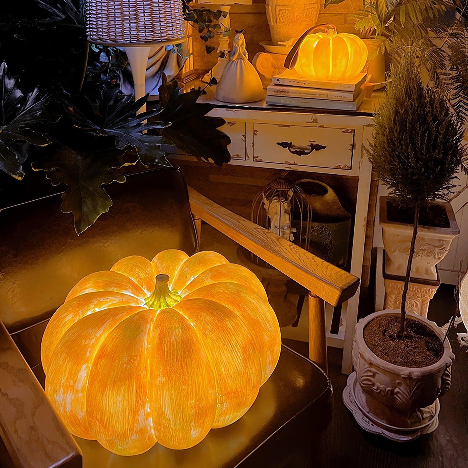 Yellow pumpkin-shaped portable table lamp with warm LED glow in a cozy living room setting
