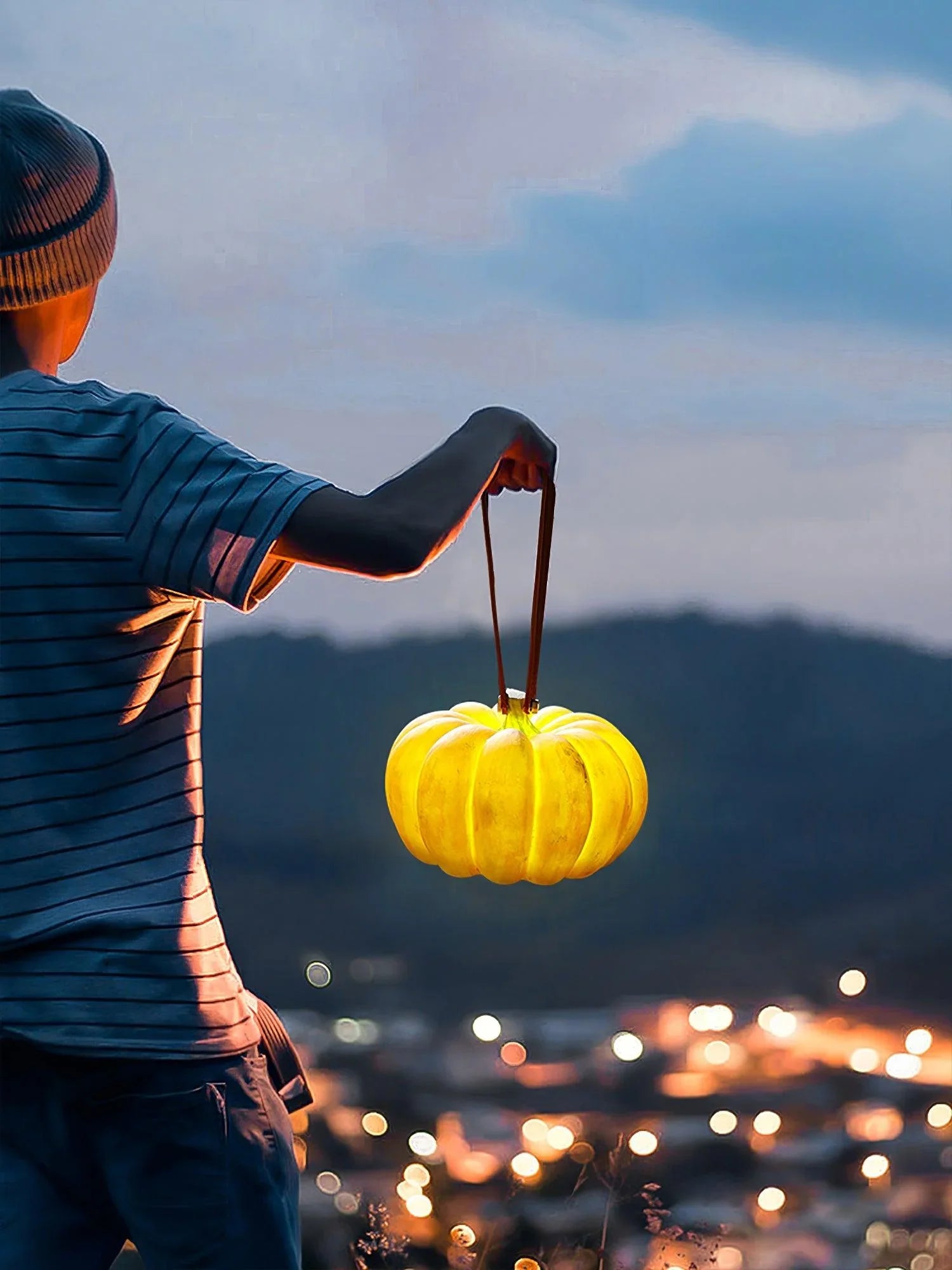Person holding YH Lamps pumpkin-shaped yellow portable table lamp outdoors at dusk