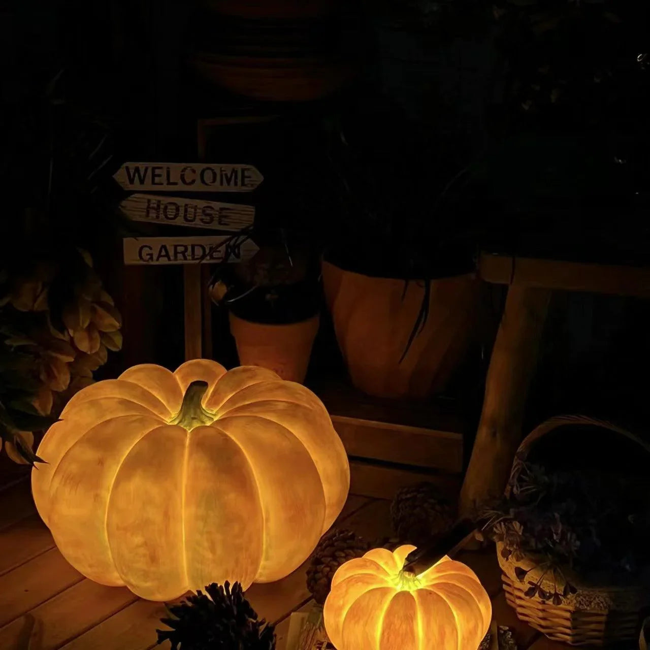 Yellow pumpkin-shaped USB portable table lamps glowing in a cozy home garden setting
