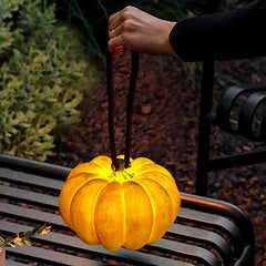 Yellow pumpkin-shaped portable table lamp with handle, outdoor setting, YH Lamps