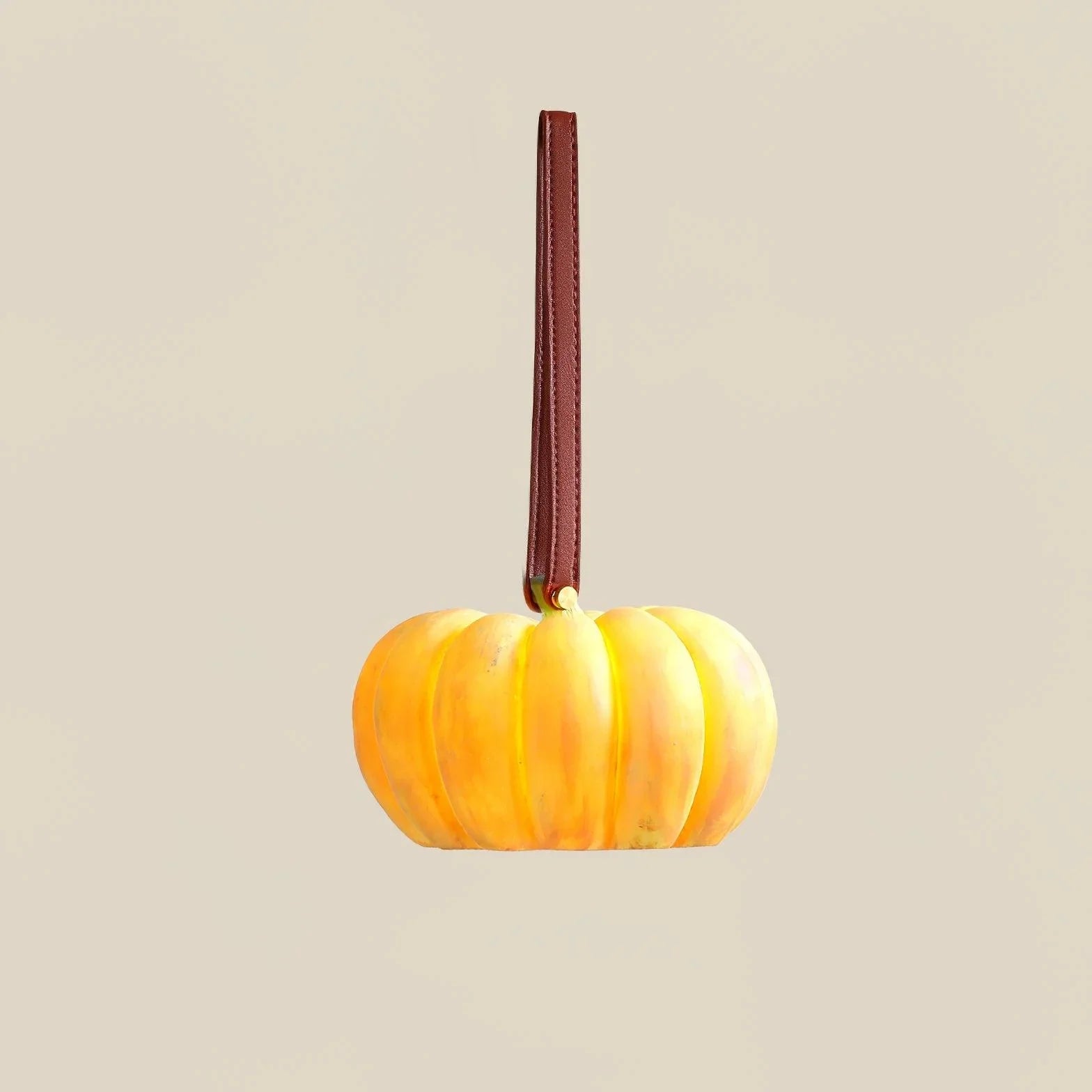 Yellow pumpkin-shaped portable table lamp with brown handle, modern lighting from YH Lamps.