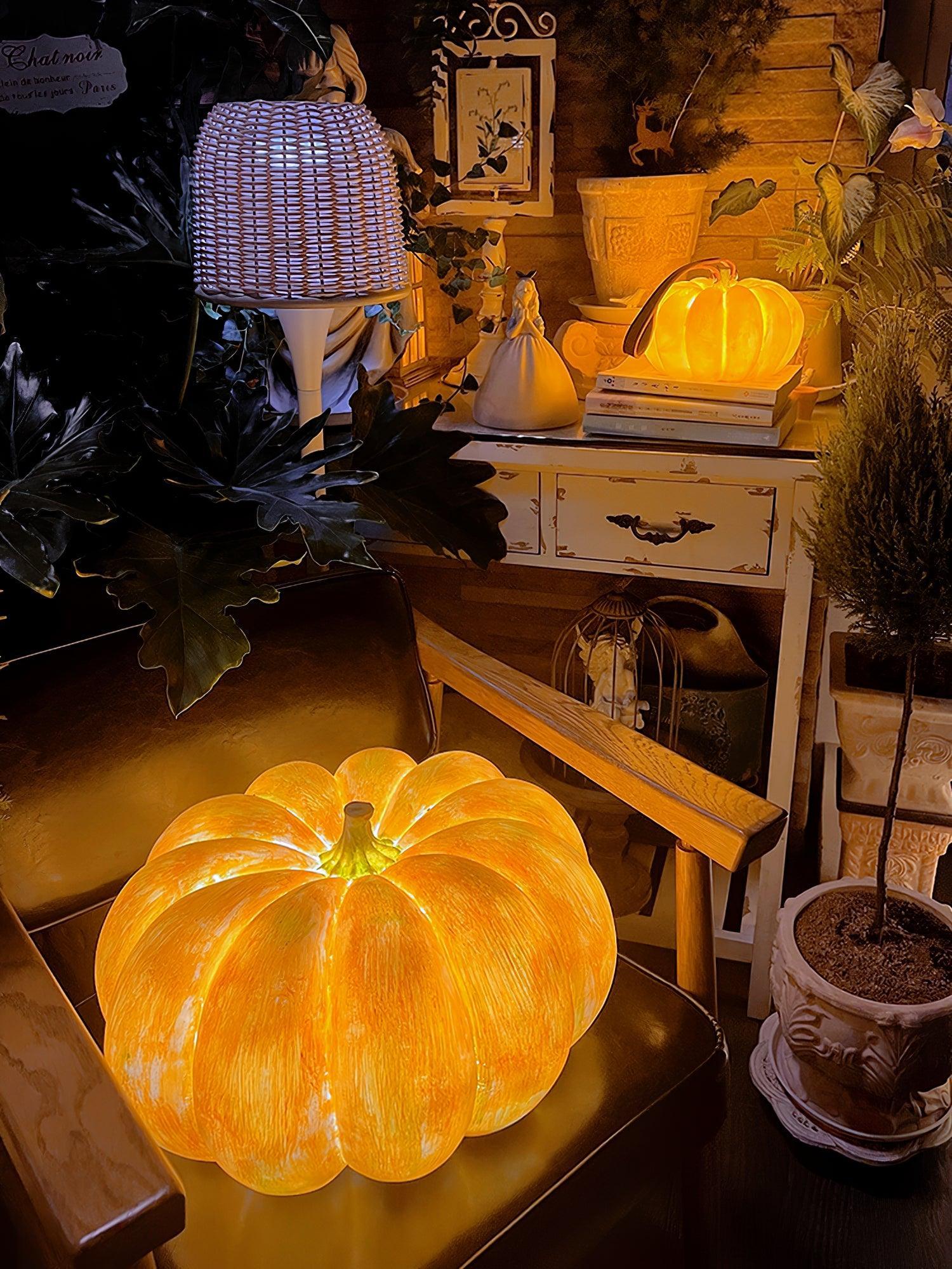 Glowing pumpkin-shaped portable table lamp on chair, cozy home decor, YH Lamps lighting design
