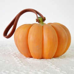 Yellow pumpkin-shaped portable table lamp with brown handle on white textured surface, YH Lamps