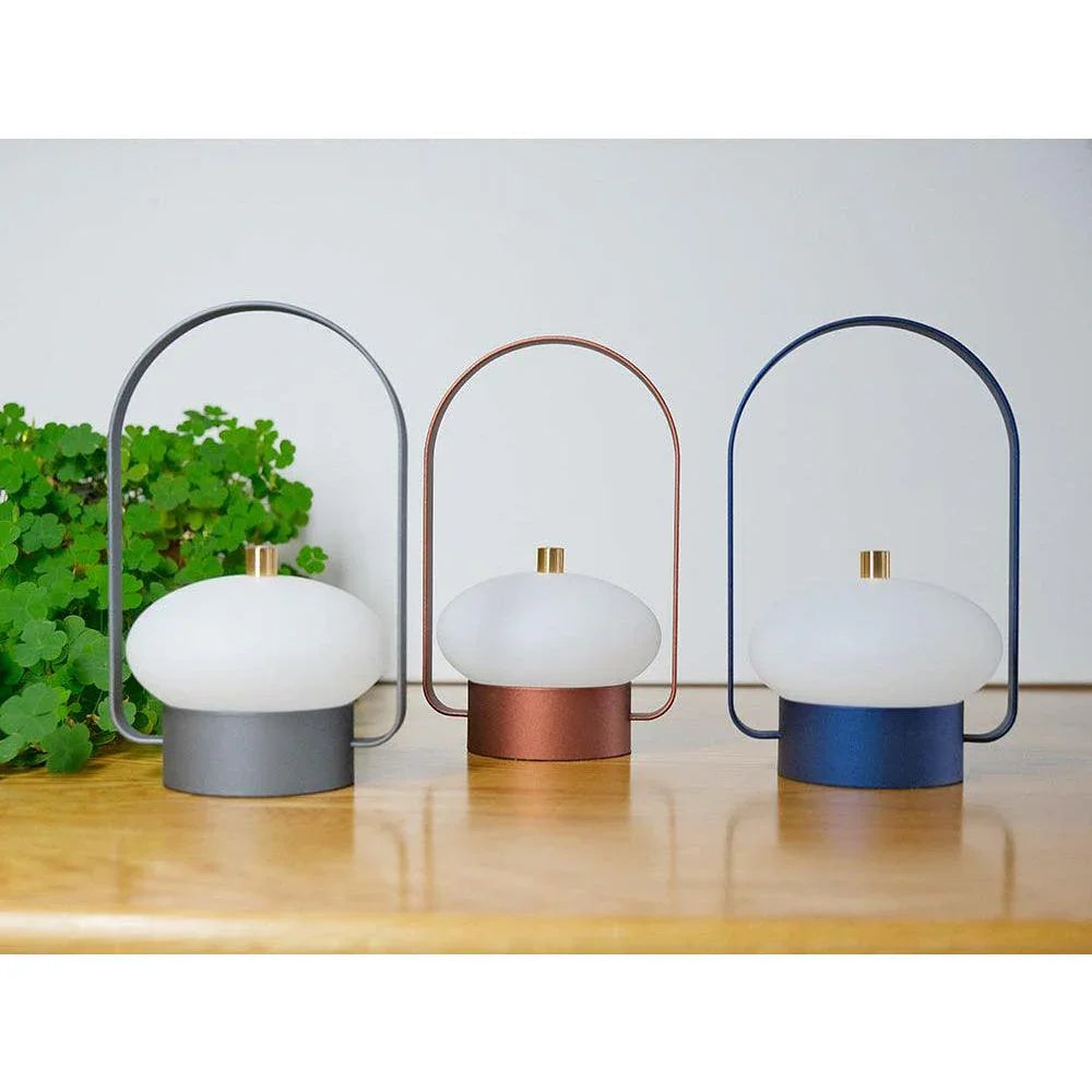 Modern YH Lamps table lamps in gray, red, and blue with oval white shades on wood surface