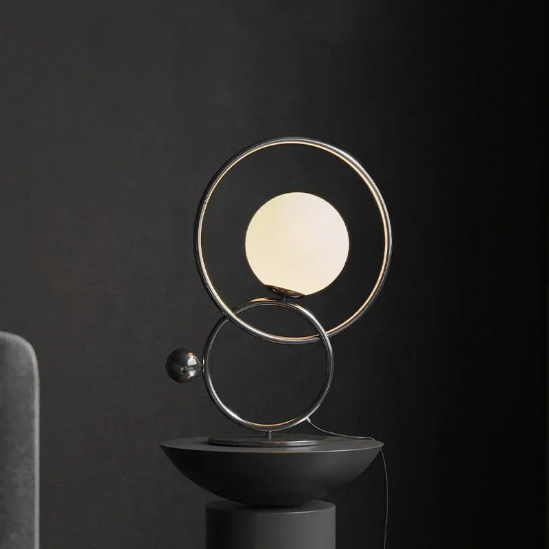 Modern designer table lamp with double ring and globe light on black background, YH Lamps