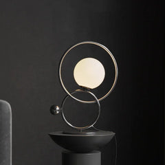 Modern designer table lamp with double ring and globe light on black background, YH Lamps