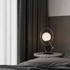 Modern designer table lamp with double rings and globe bulb on marble nightstand by YH Lamps