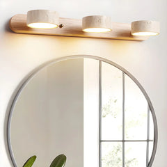 Modern 3-light walnut wall lamp with warm travertine shades above round mirror in minimalist room