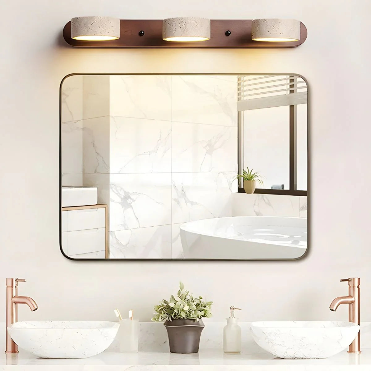 Modern bathroom with walnut color 3-light wall lamp above rectangular mirror, marble sinks, and copper faucets