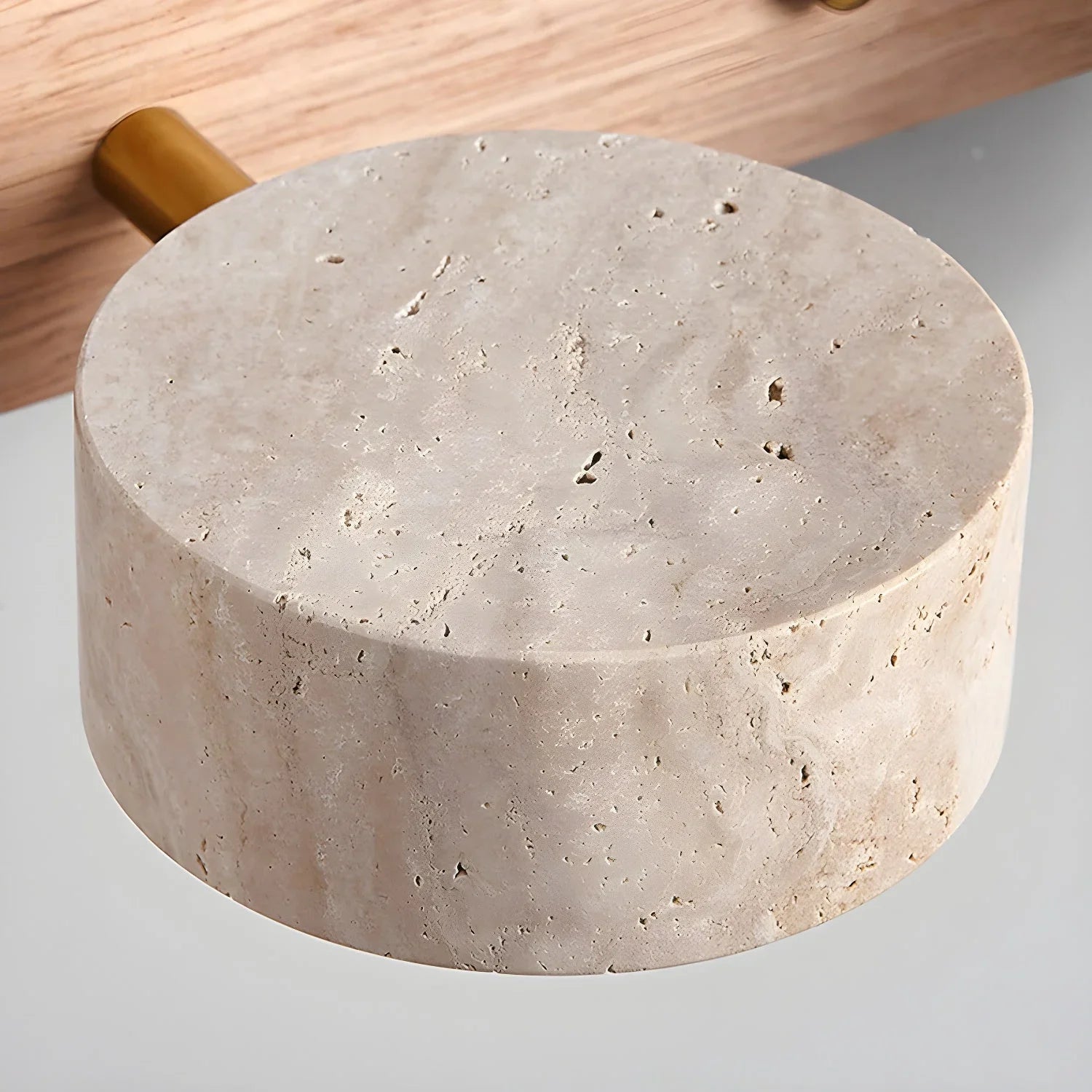 Modern travertine round wall lamp with walnut color and warm lighting, mounted on wood