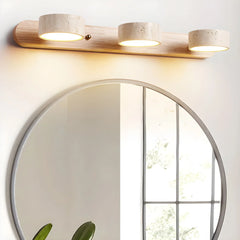 Triple 3-light travertine wall sconce with walnut wood base above round mirror in modern interior