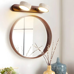 Warm light walnut wall lamp with two round travertine shades above round wooden mirror, modern home decor