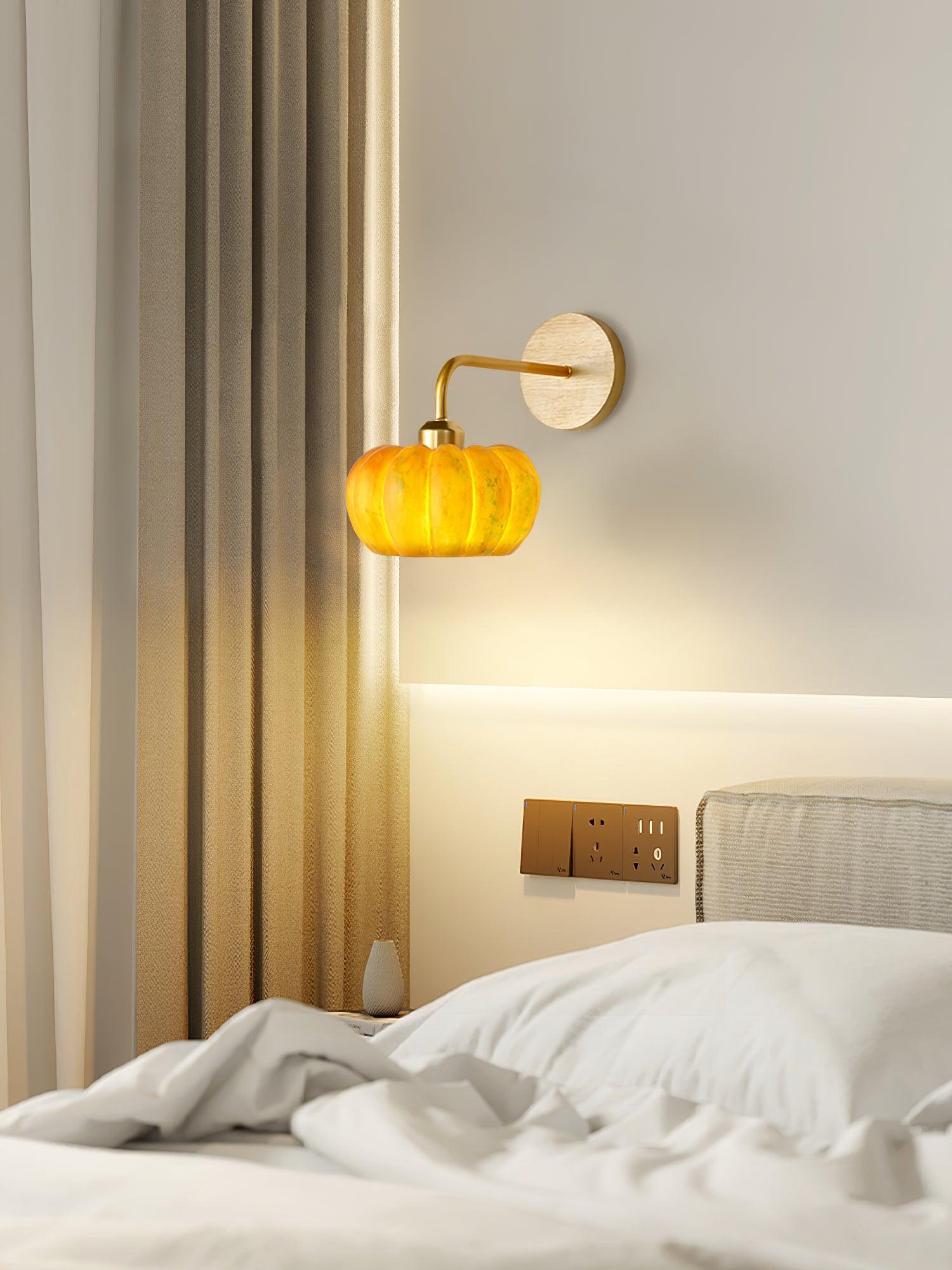 Yellow gold pumpkin-shaped wall lamp by YH Lamps in a modern bedroom setting