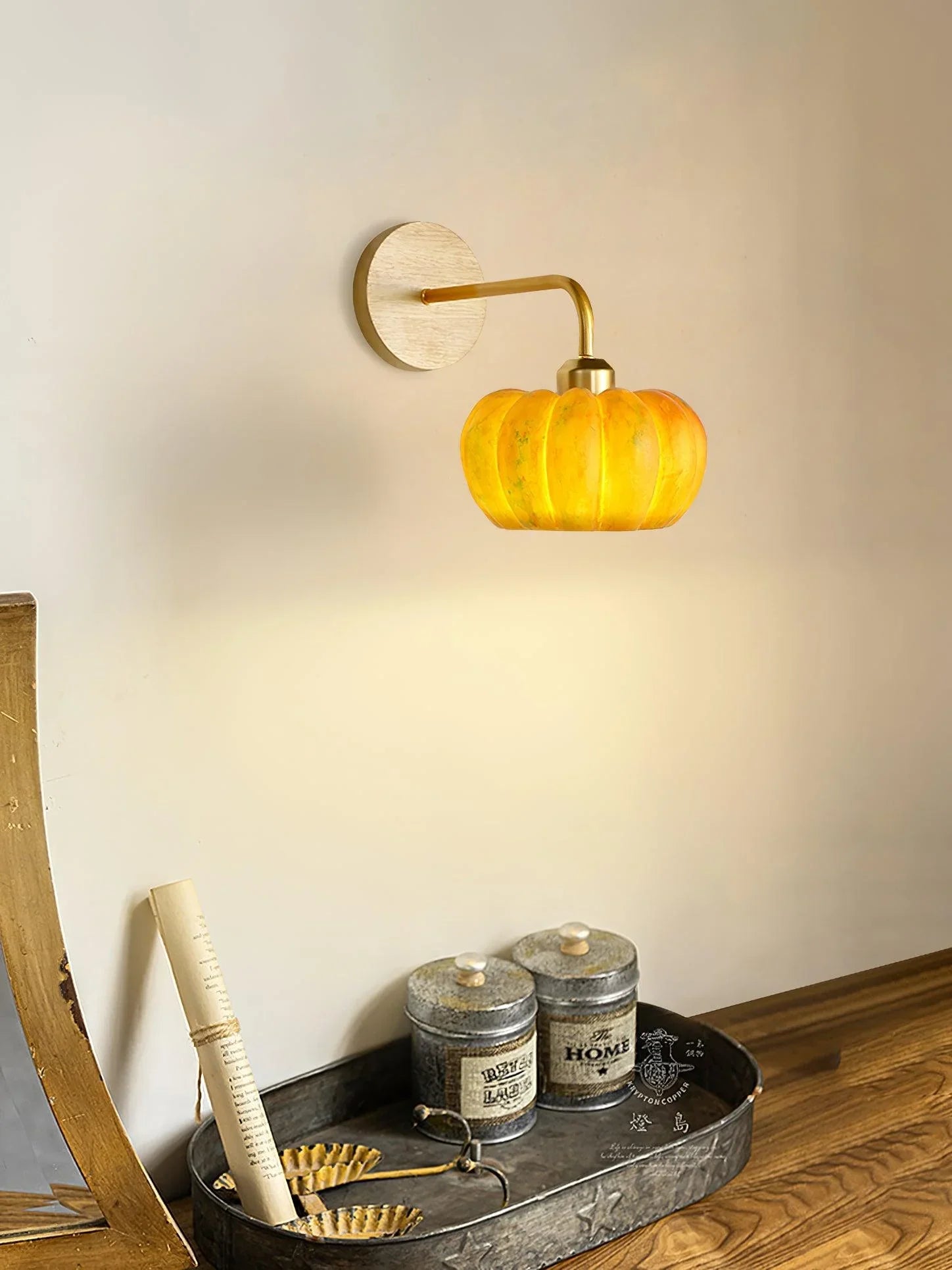 Yellow gold pumpkin-shaped wall lamp on white wall, modern decor by YH Lamps