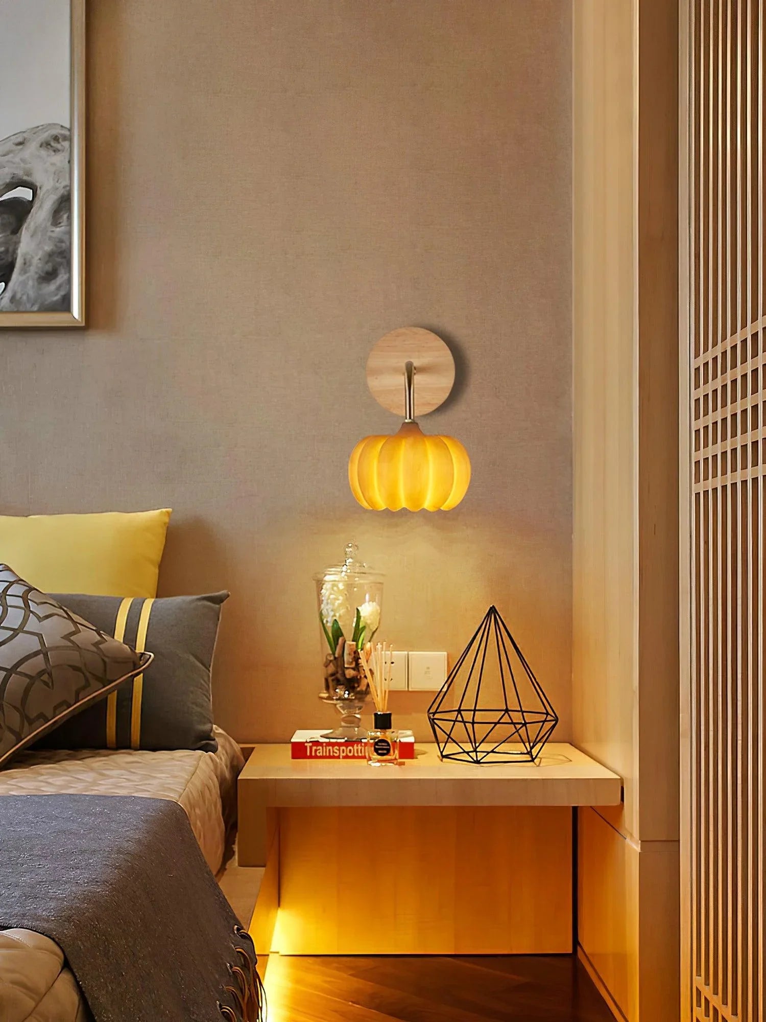 Yellow gold pumpkin wall lamp from YH Lamps mounted in a modern bedroom setting