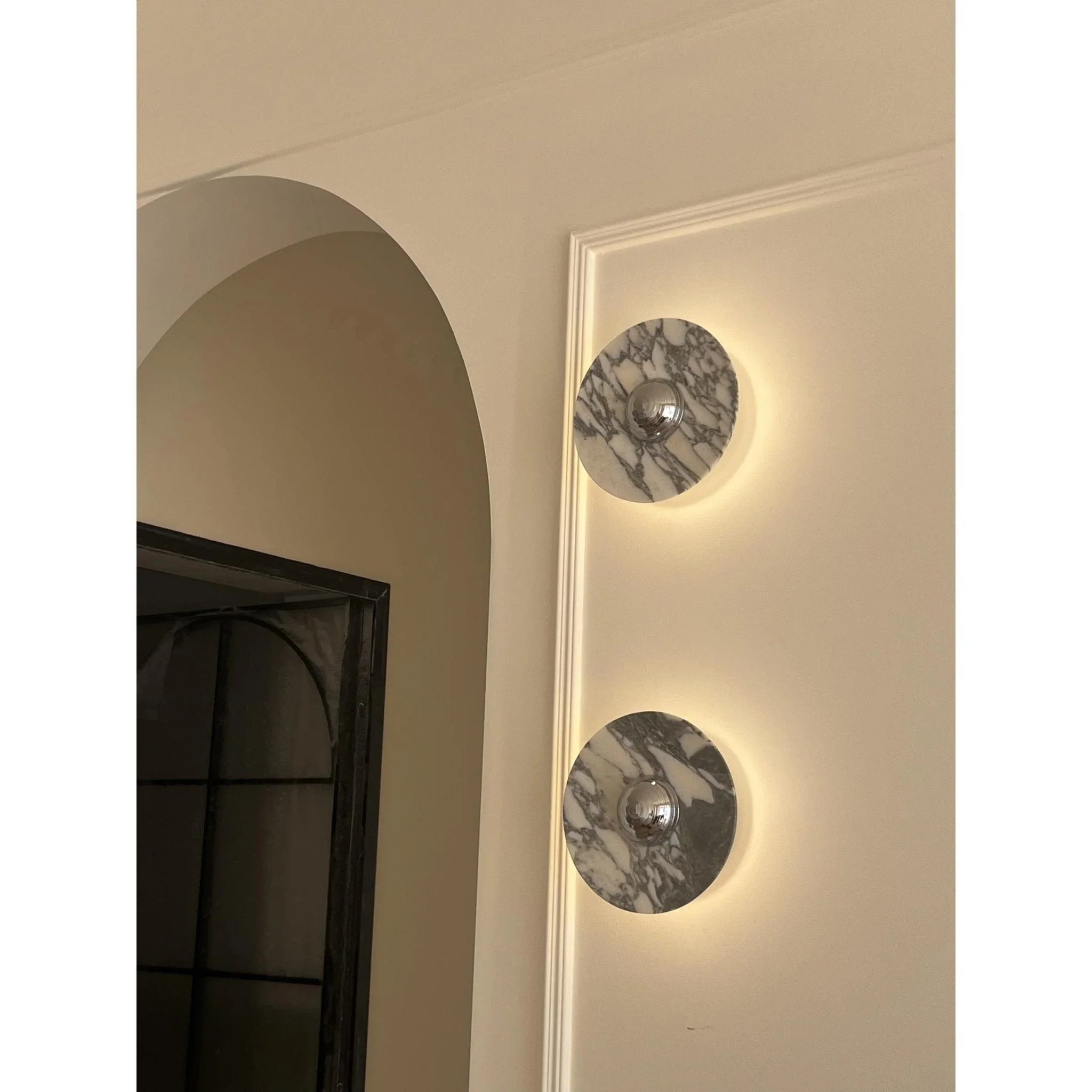 Modern marble wall sconces with chrome accents and warm LED light in elegant interior