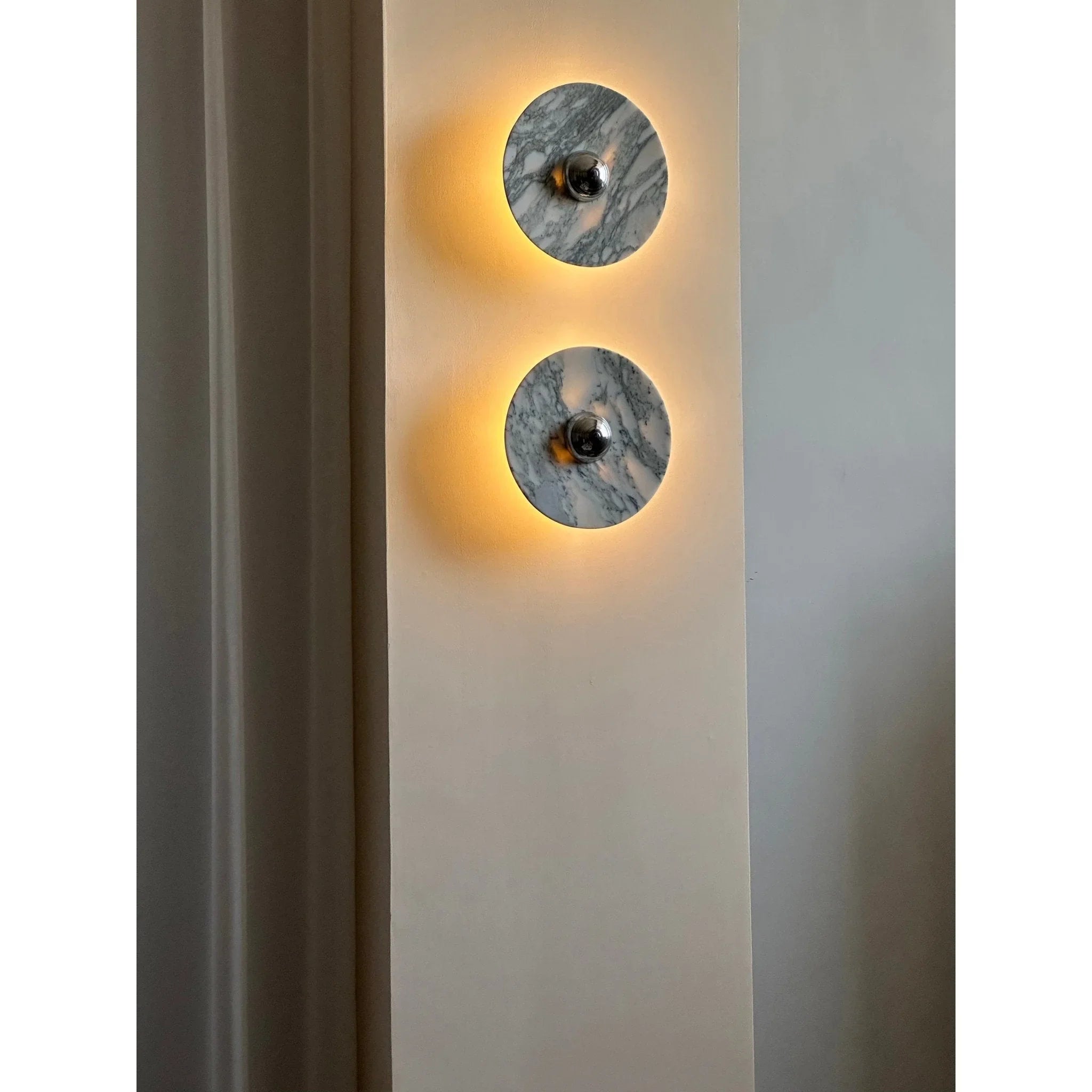 Modern marble wall sconces with warm light on a neutral wall, YH Lamps contemporary lighting