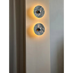 Modern marble wall sconces with warm light on a neutral wall, YH Lamps contemporary lighting