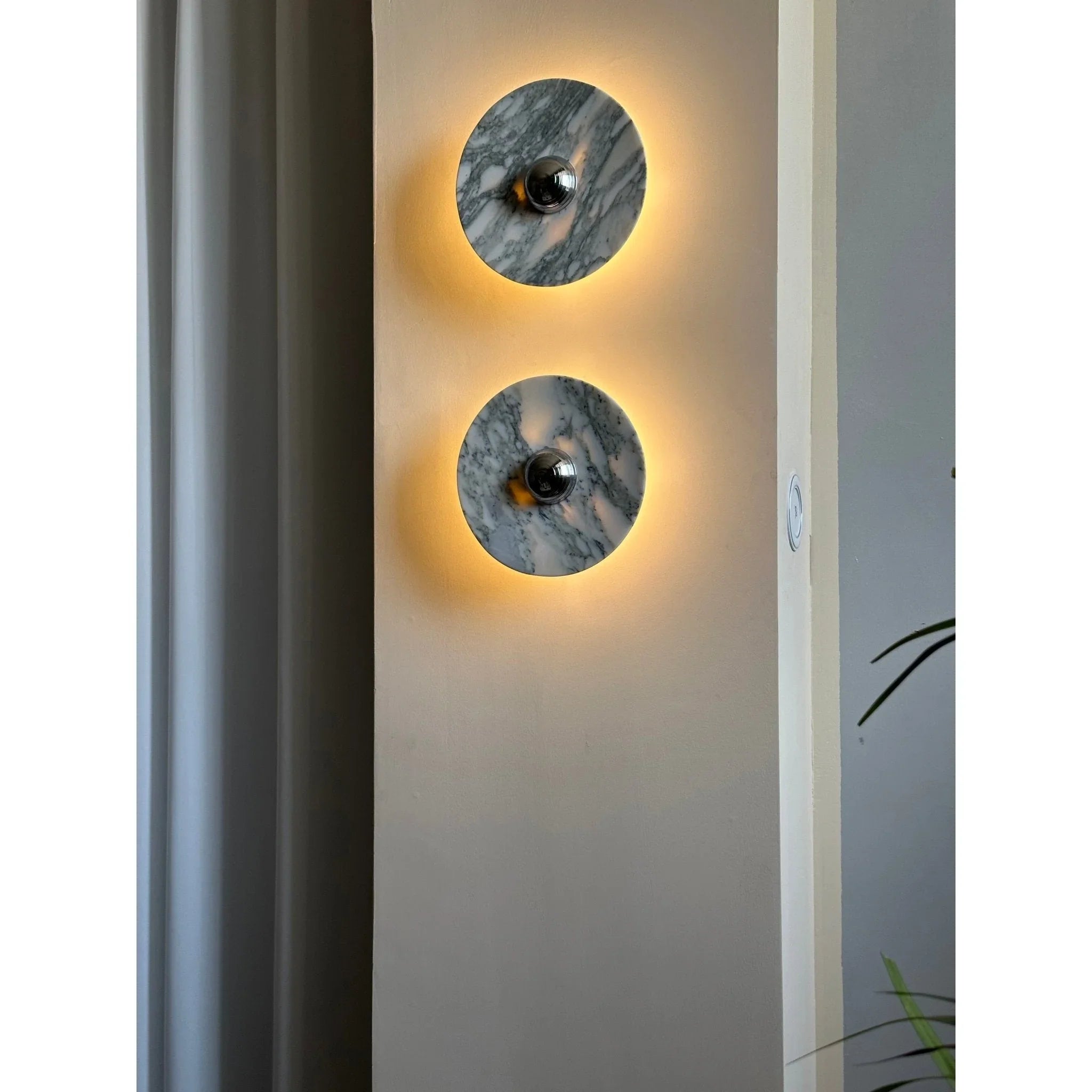 Modern marble wall sconces with warm backlighting on a neutral wall, YH Lamps home lighting