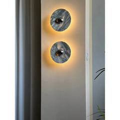 Modern marble wall sconces with warm backlighting on a neutral wall, YH Lamps home lighting