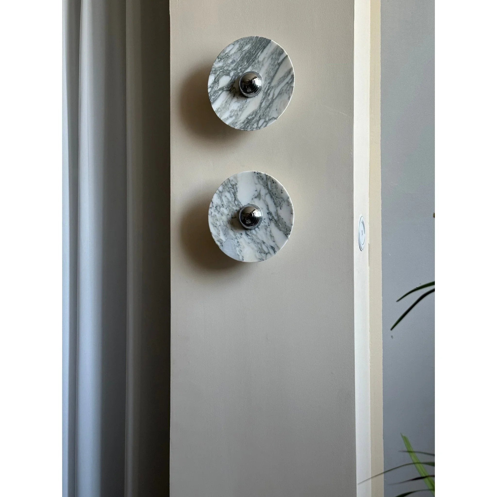 Modern marble wall lamps with chrome accents mounted on a beige wall, YH Lamps lighting
