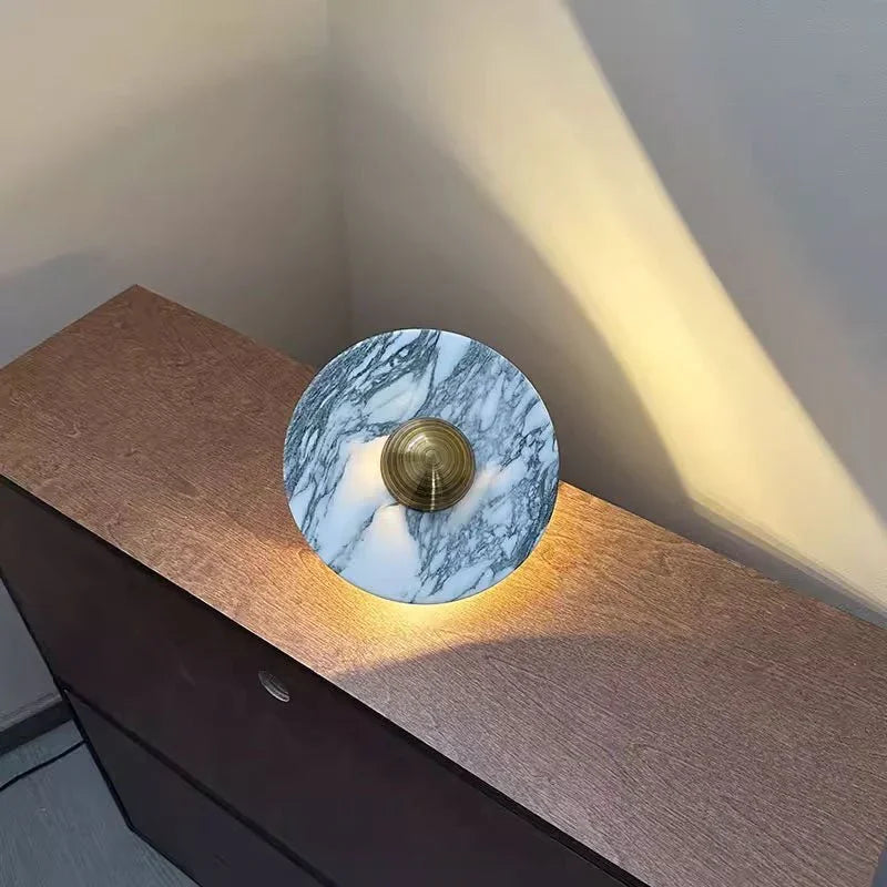 Modern marble wall lamp with brass accent on wood cabinet, warm light, YH Lamps