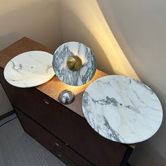 Modern marble wall lamp with chrome touch switch on a wooden console, soft warm light