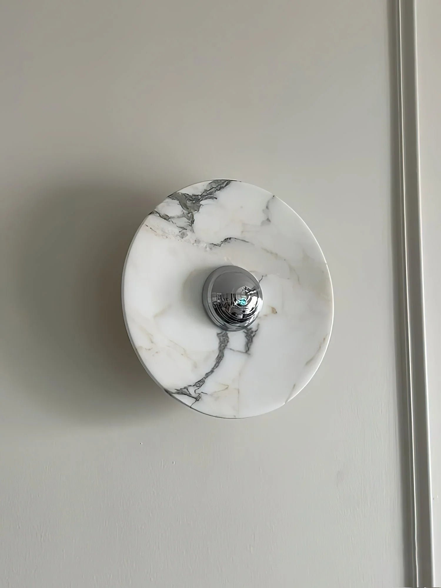 Modern marble wall lamp with chrome accent on light gray wall from YH Lamps