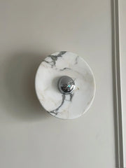 Modern marble wall lamp with chrome accent on light gray wall from YH Lamps