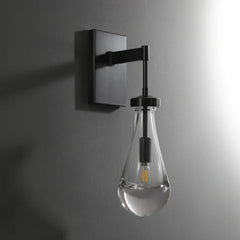 Modern raindrop glass wall sconce by YH Lamps mounted on a gray wall, elegant lighting design.