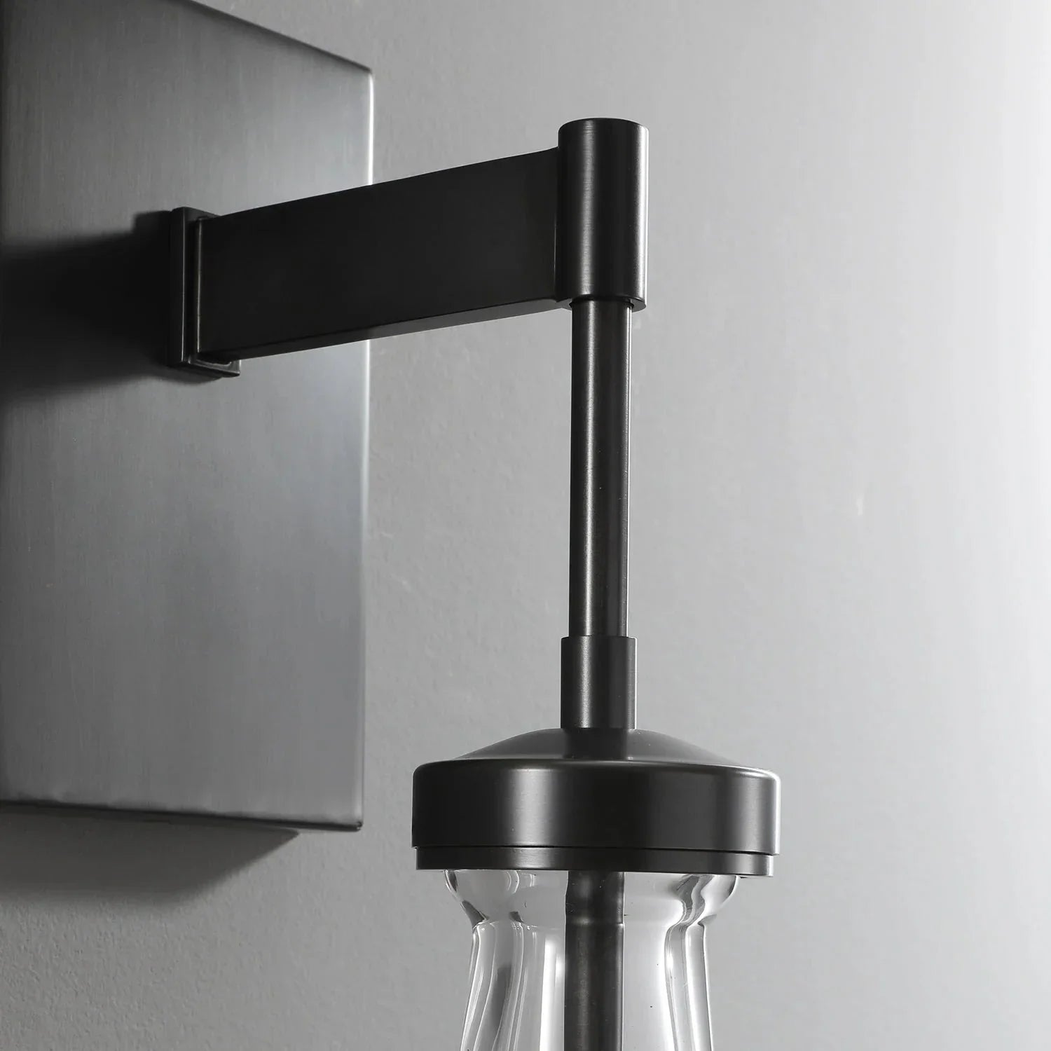 Modern black metal wall sconce with clear raindrop glass shade by YH Lamps